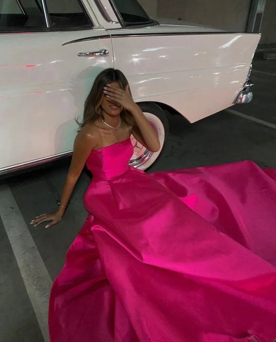 Close-up detail of the pink satin fabric on the sleeveless prom dress.