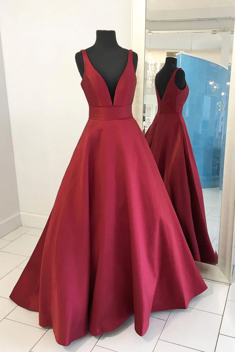 Woman wearing an elegant red satin V-neck long prom dress.