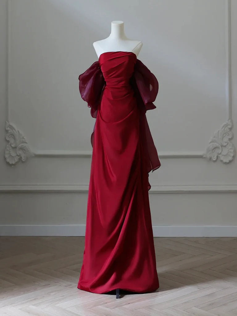 Model wearing an elegant burgundy satin long prom dress with a V-neckline.