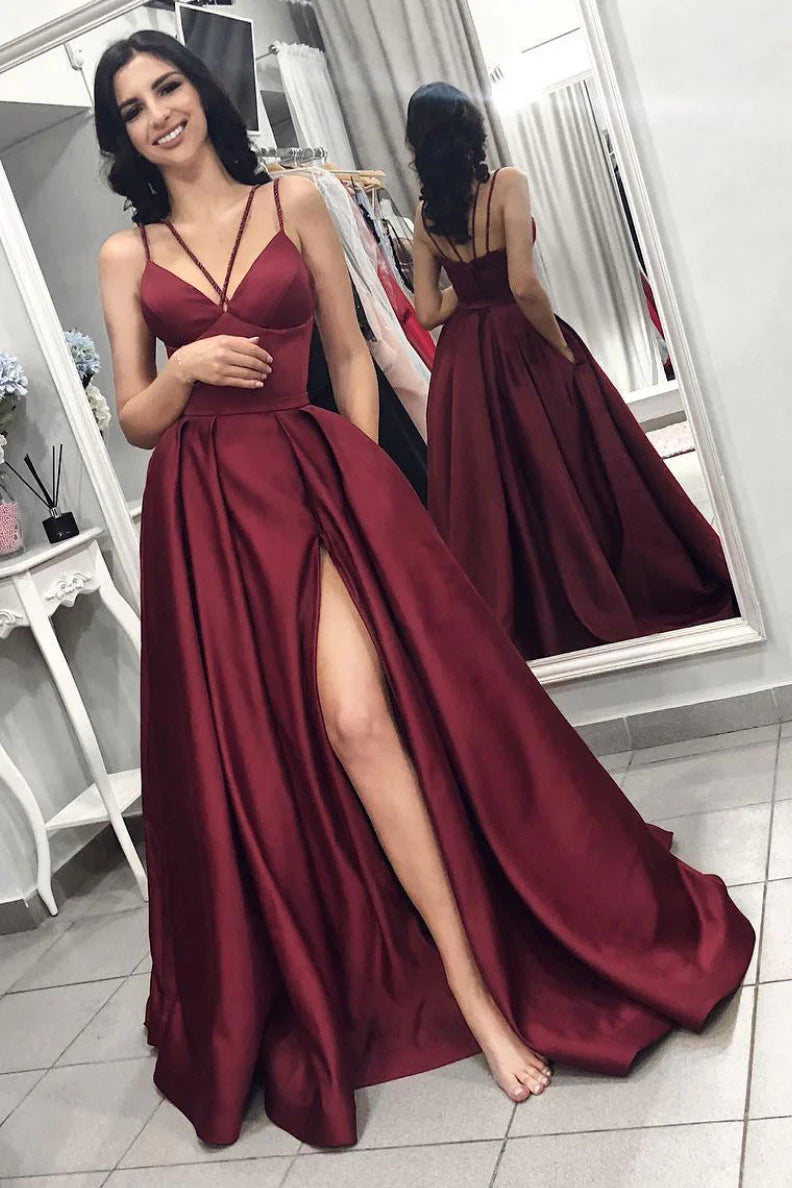 Woman wearing an elegant burgundy satin long prom dress.