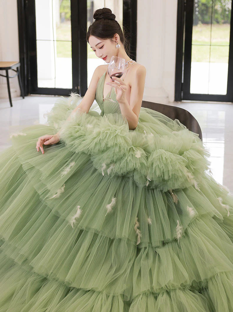 Model wearing a long green V-neck tulle prom dress.