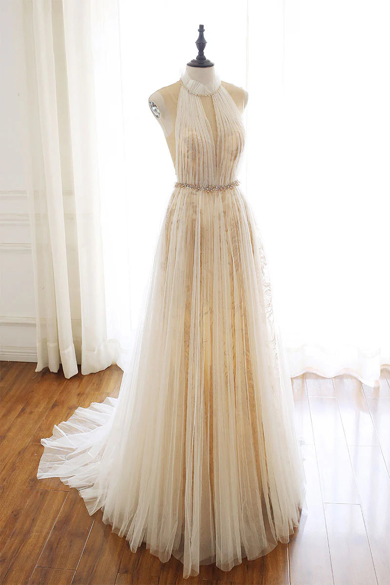 Full front view of model wearing a light champagne tulle lace long prom dress.