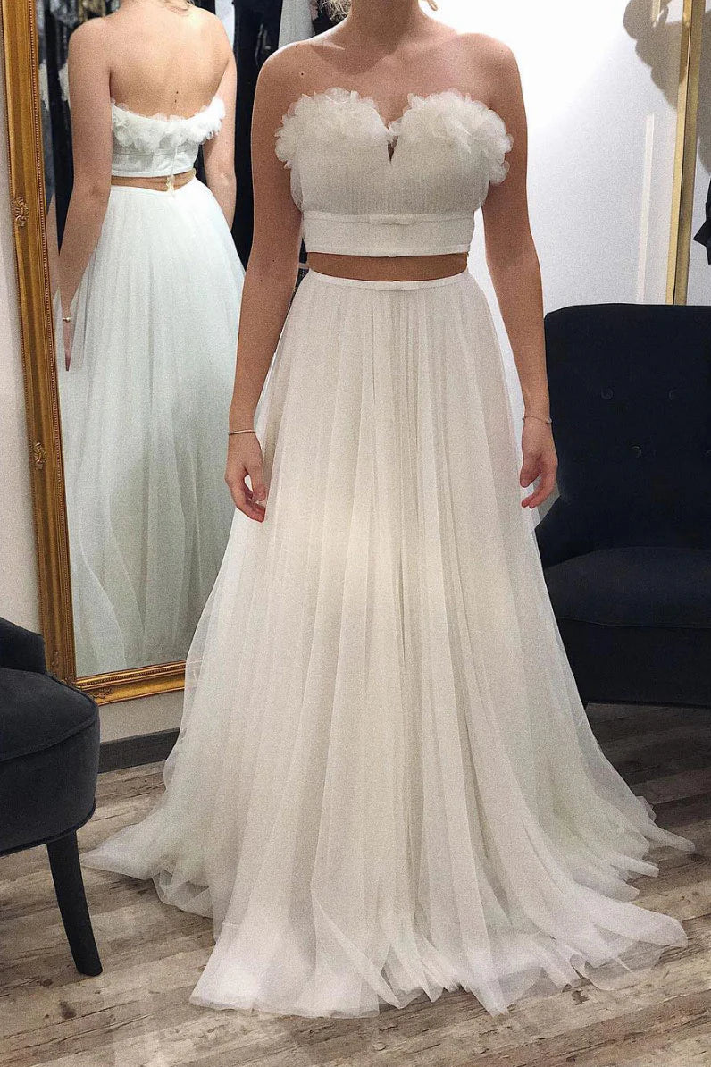 Elegant white tulle long prom dress with a cinched waist.