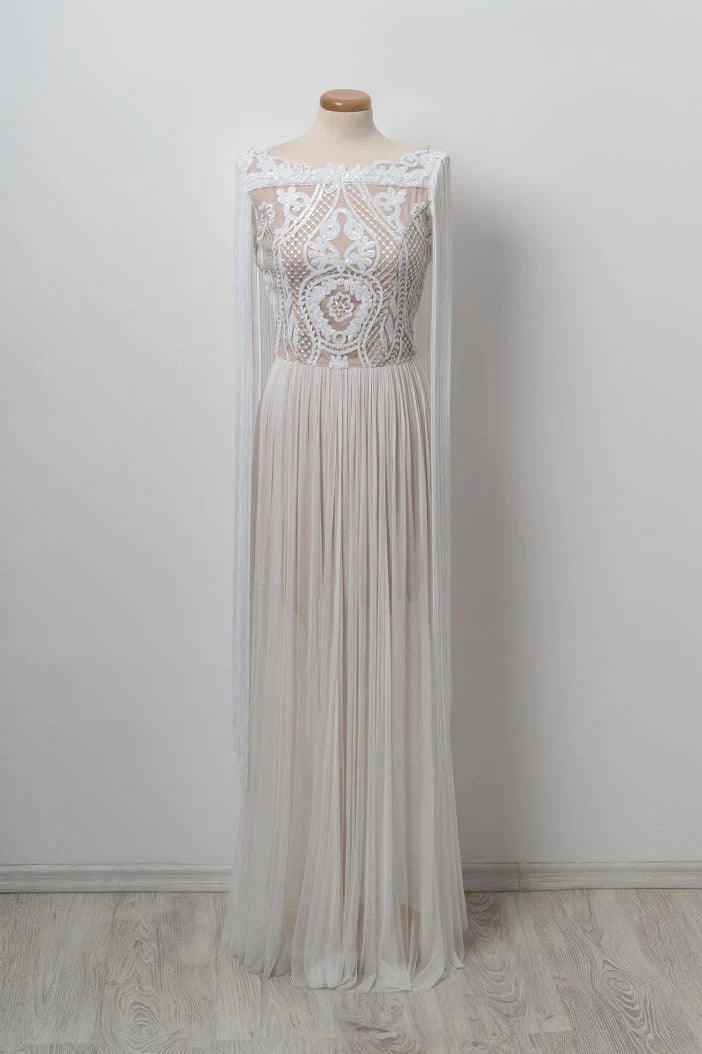 Woman wearing an elegant white lace long prom dress with a V-neck and A-line silhouette.