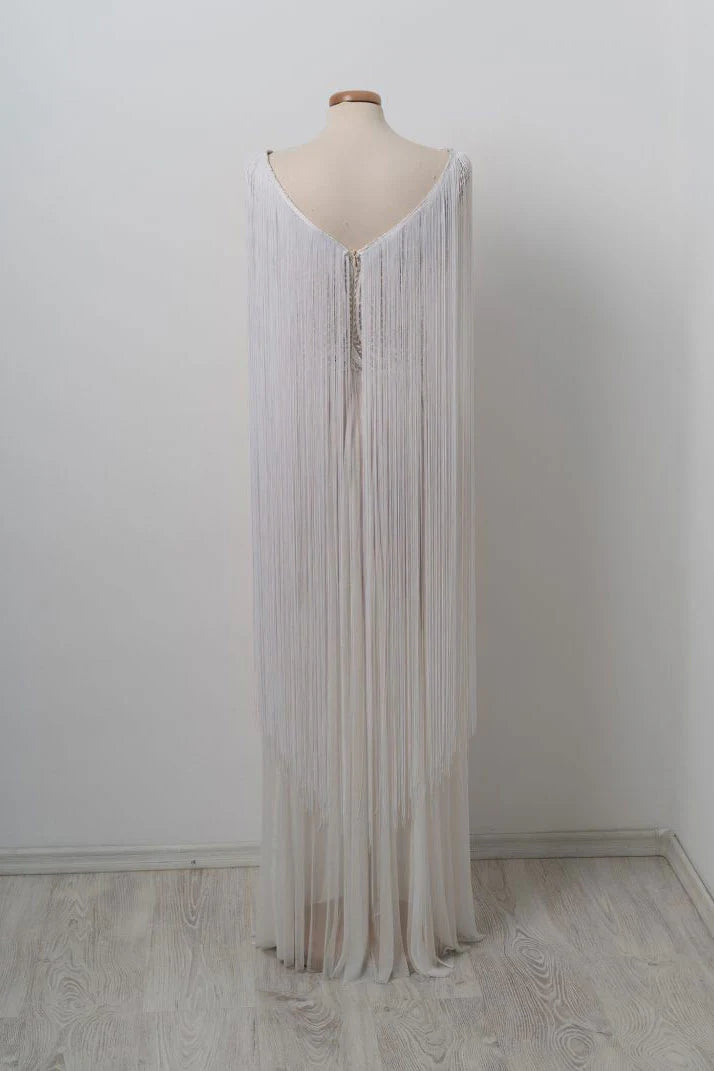 Back view of a woman in a white lace long prom dress, showcasing the intricate lace details.