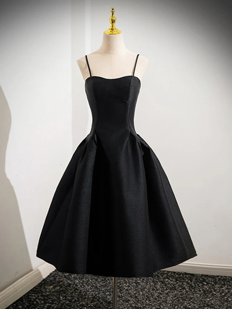 Woman wearing a black A-line satin short dress with spaghetti straps and a V-neck.