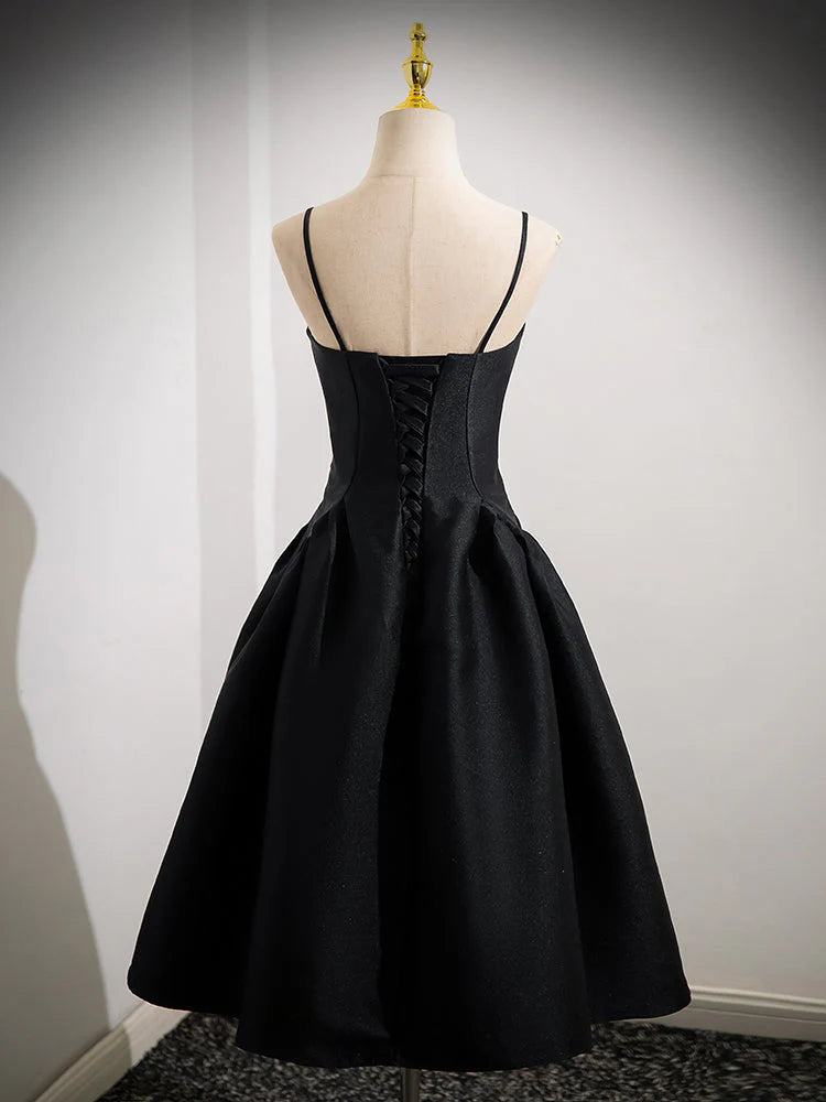 Back view of a woman in a black A-line satin short dress, showcasing the skirt flow.