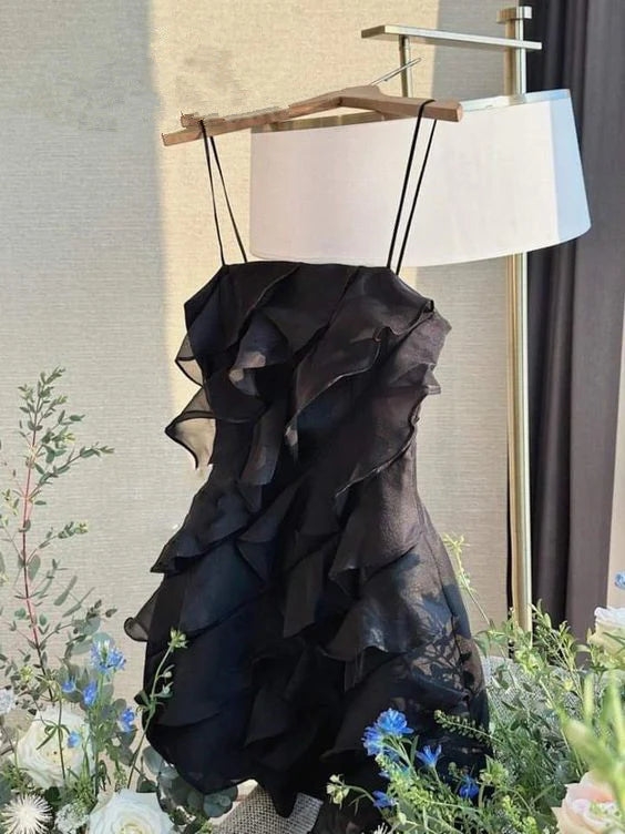 Model wearing an elegant black tulle spaghetti strap homecoming dress.