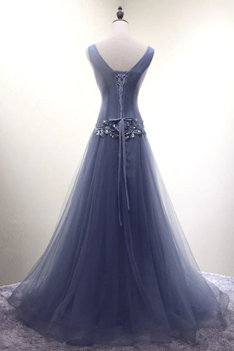 Close-up of the intricate beadwork and V-neckline on the tulle dress.