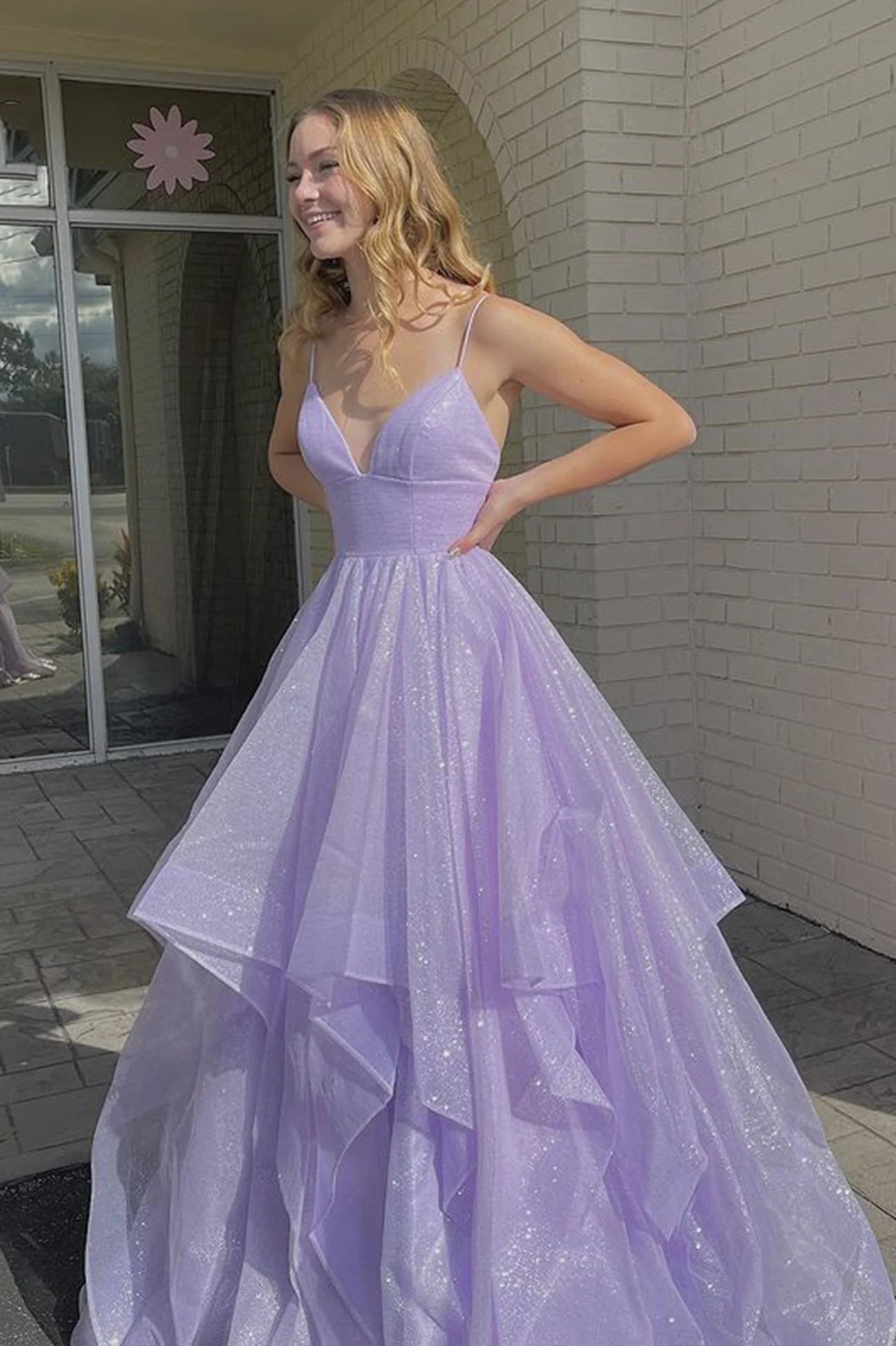 Woman wearing an elegant purple V-neck tulle A-line long prom dress.