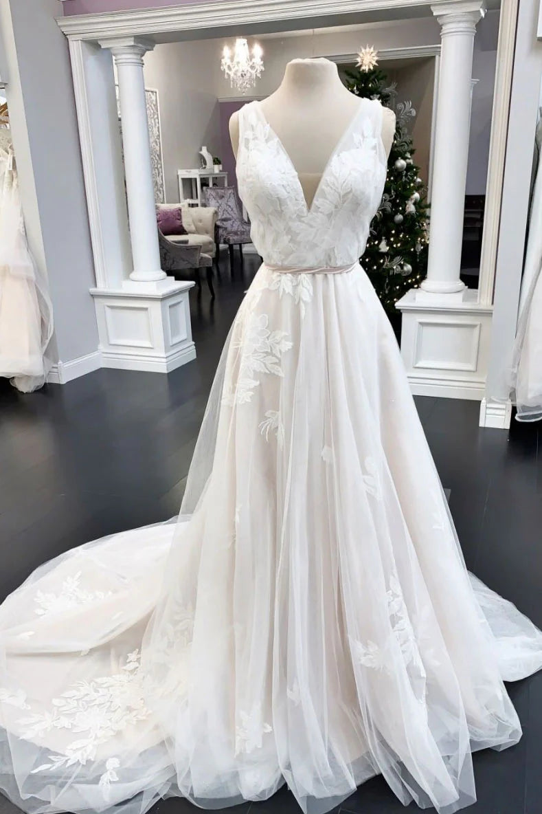 Elegant woman wearing a white V-neck tulle lace long prom dress with an A-line skirt.