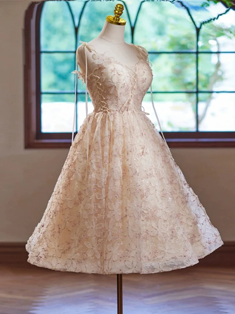 Back view of a model in a champagne A-line V-neck short homecoming dress.