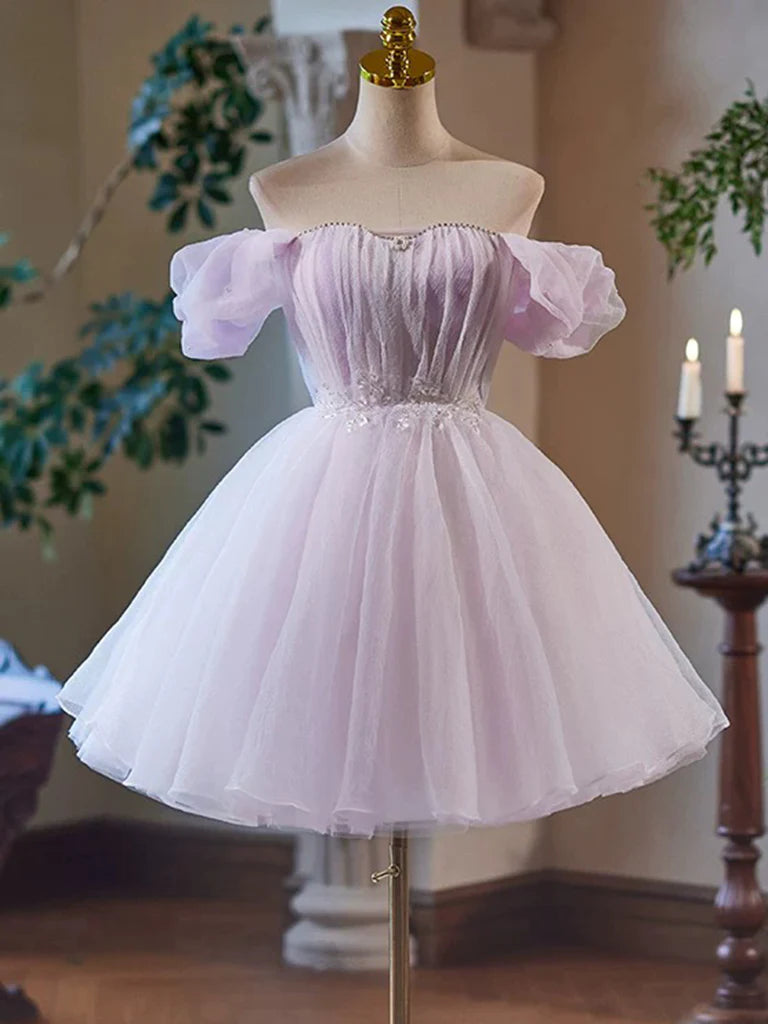 Woman wearing an elegant A-line V-neck short prom dress with off-shoulder tulle and lace.