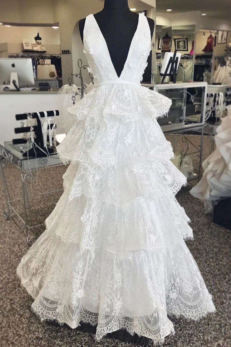 Woman wearing a white V-neck tulle lace long A-line prom dress.