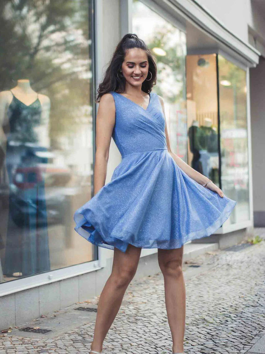 Woman wearing a blue V-neck short tulle prom dress.