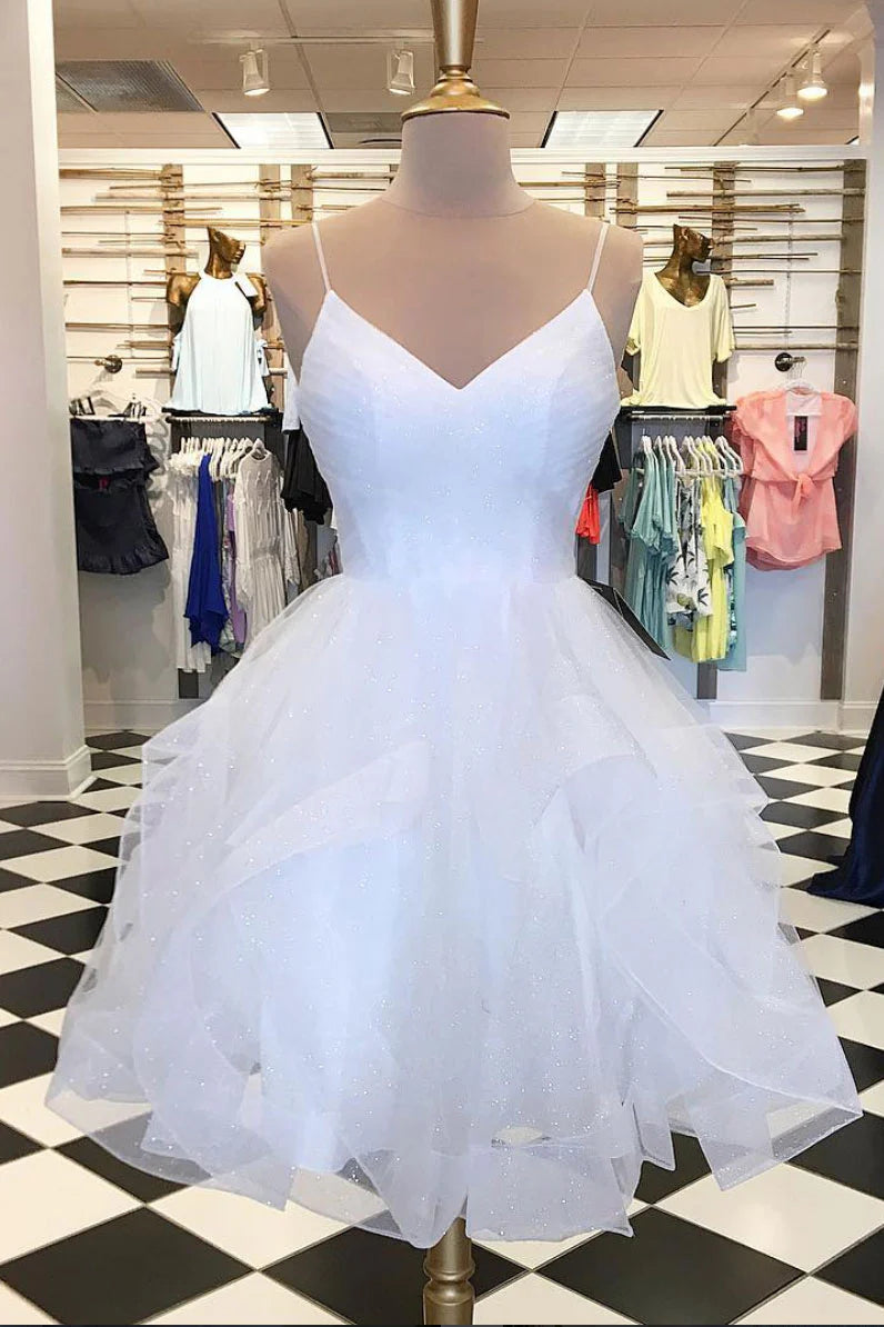 Woman wearing a white V-neck tulle short prom dress with an A-line silhouette.