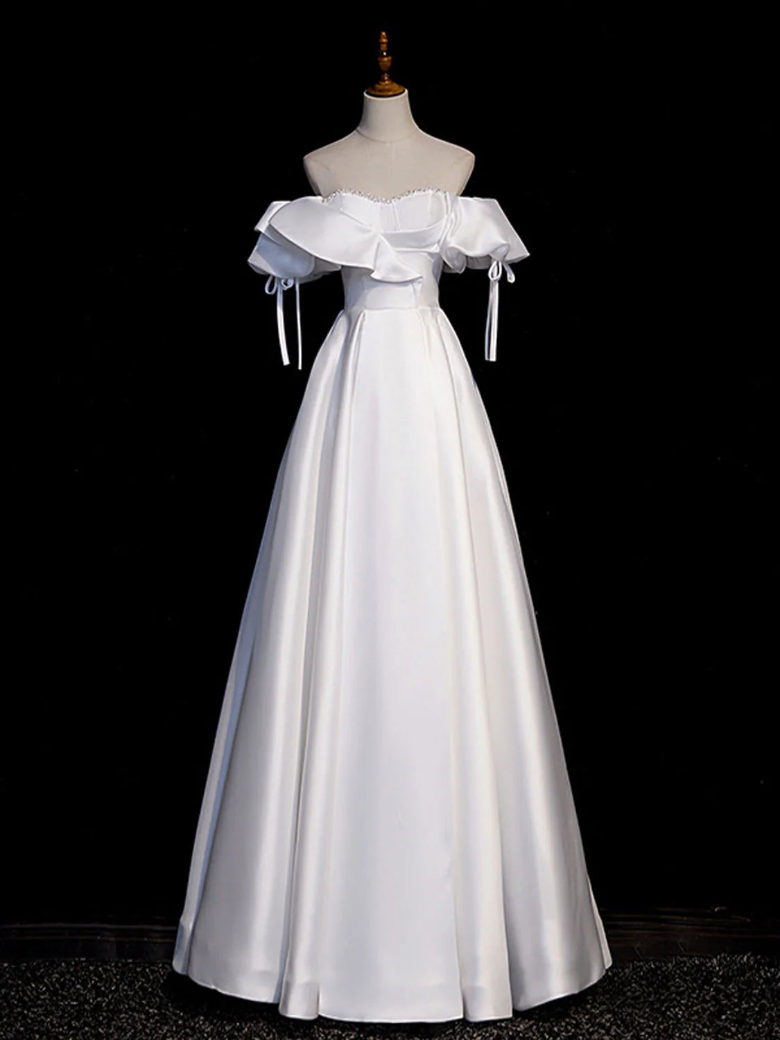 Front view of a woman wearing an elegant white A-line satin long prom dress.