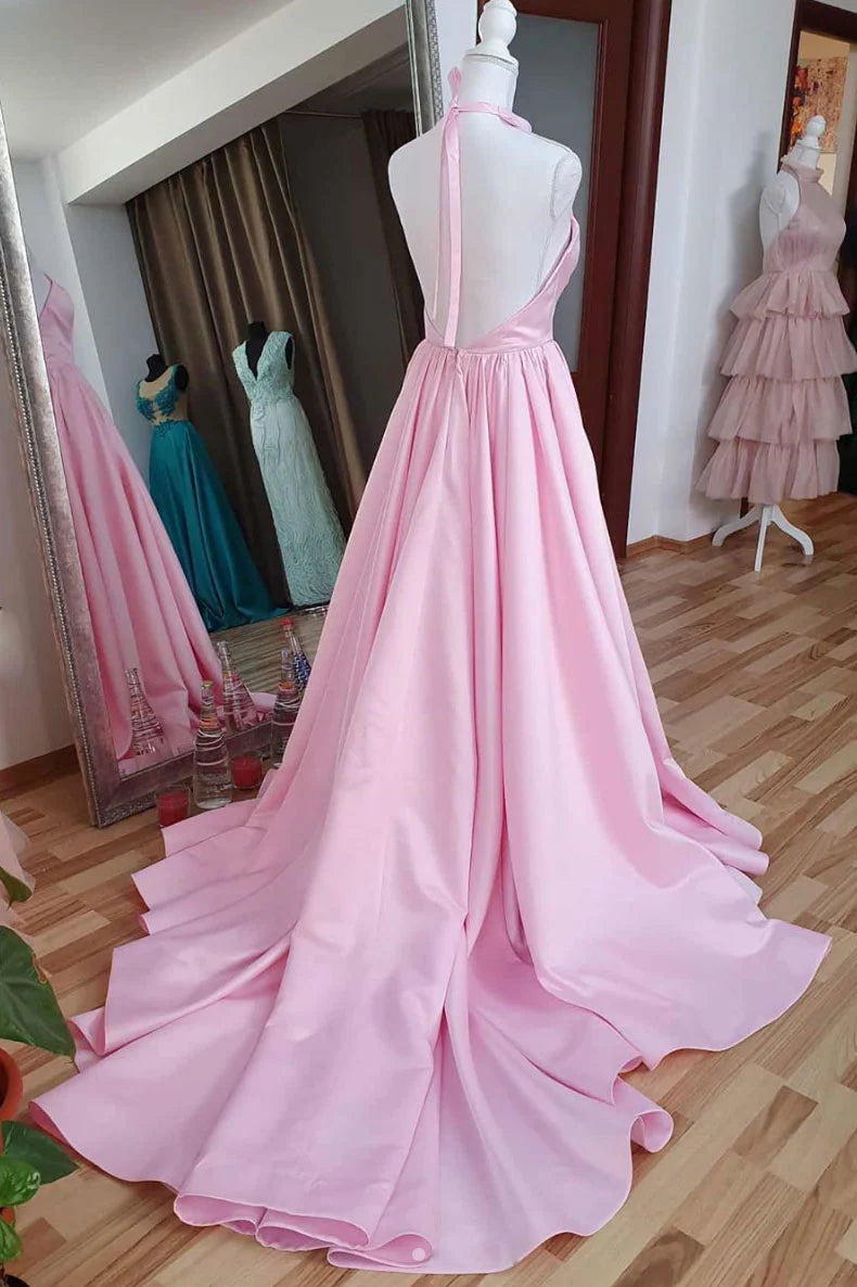Back view of a woman wearing a pink satin high neck evening gown.
