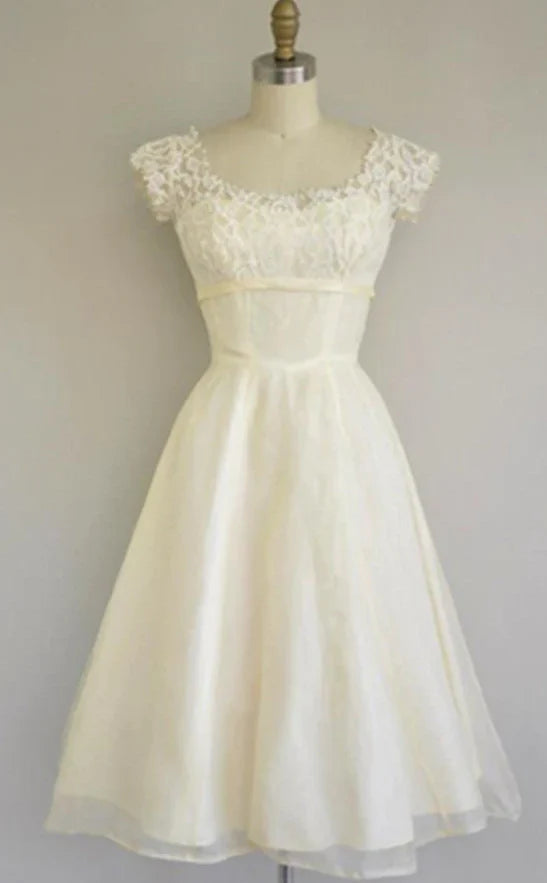 Woman wearing an elegant ivory lace A-line beach wedding dress.