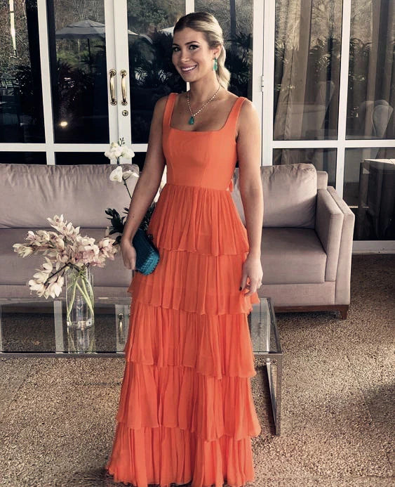 Sleeveless orange A-line chiffon prom dress on a model.