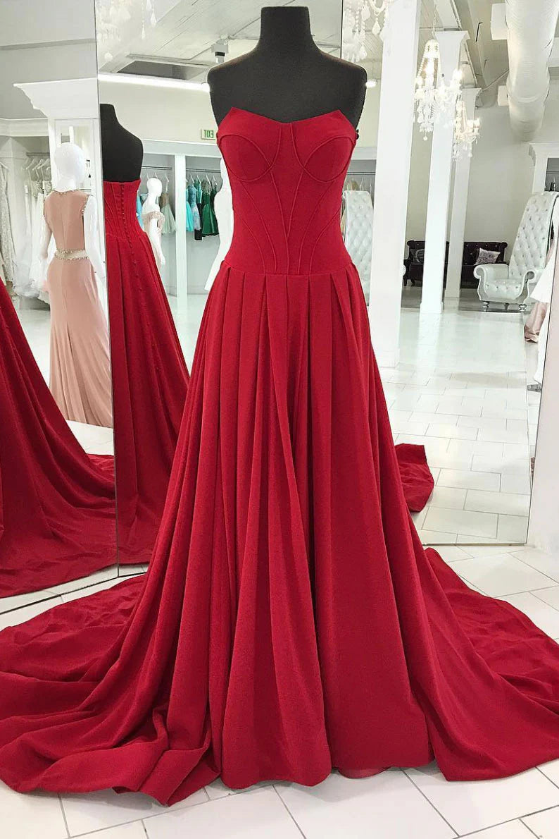Model wearing an elegant red off-shoulder long prom dress.
