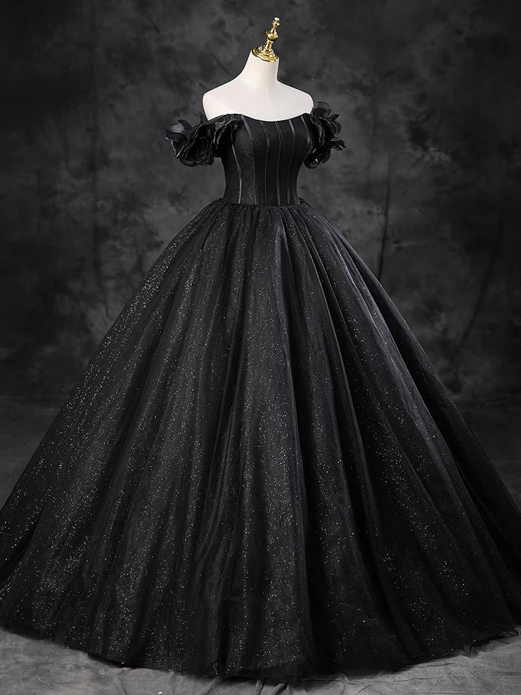A-line off-shoulder black tulle long evening gown, side view.