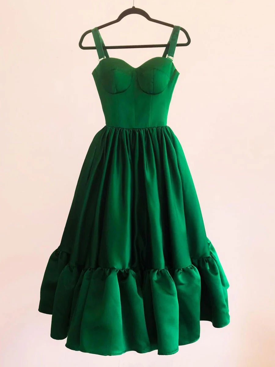 Model wearing a green satin short prom dress with a sweetheart neckline.