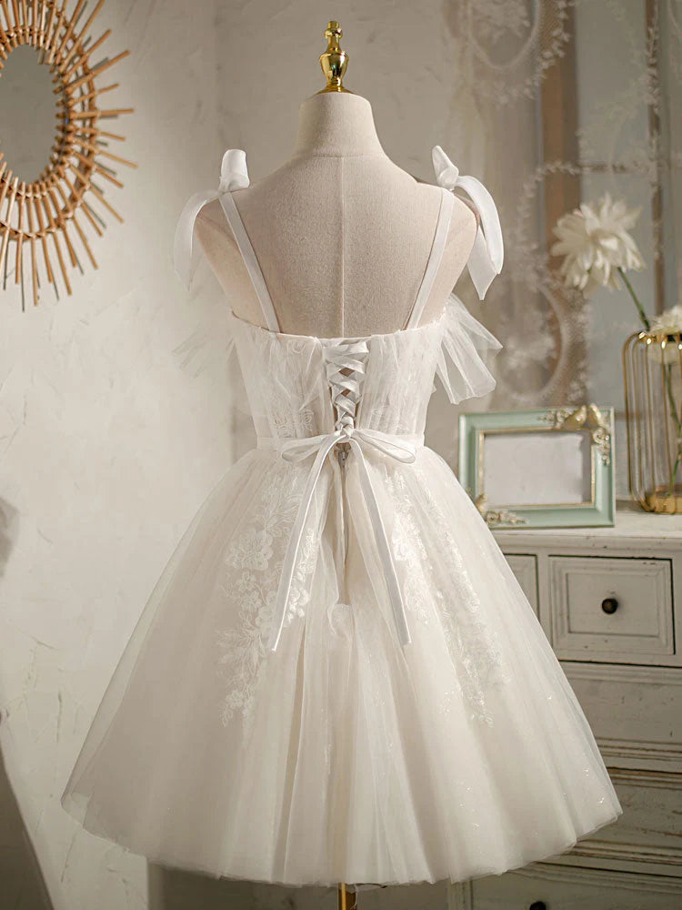 Back view of a white A-line homecoming dress with thin straps.