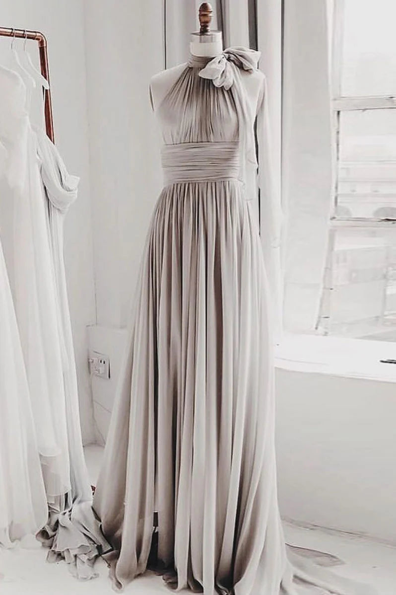 Woman wearing an elegant gray chiffon long prom or bridesmaid dress.