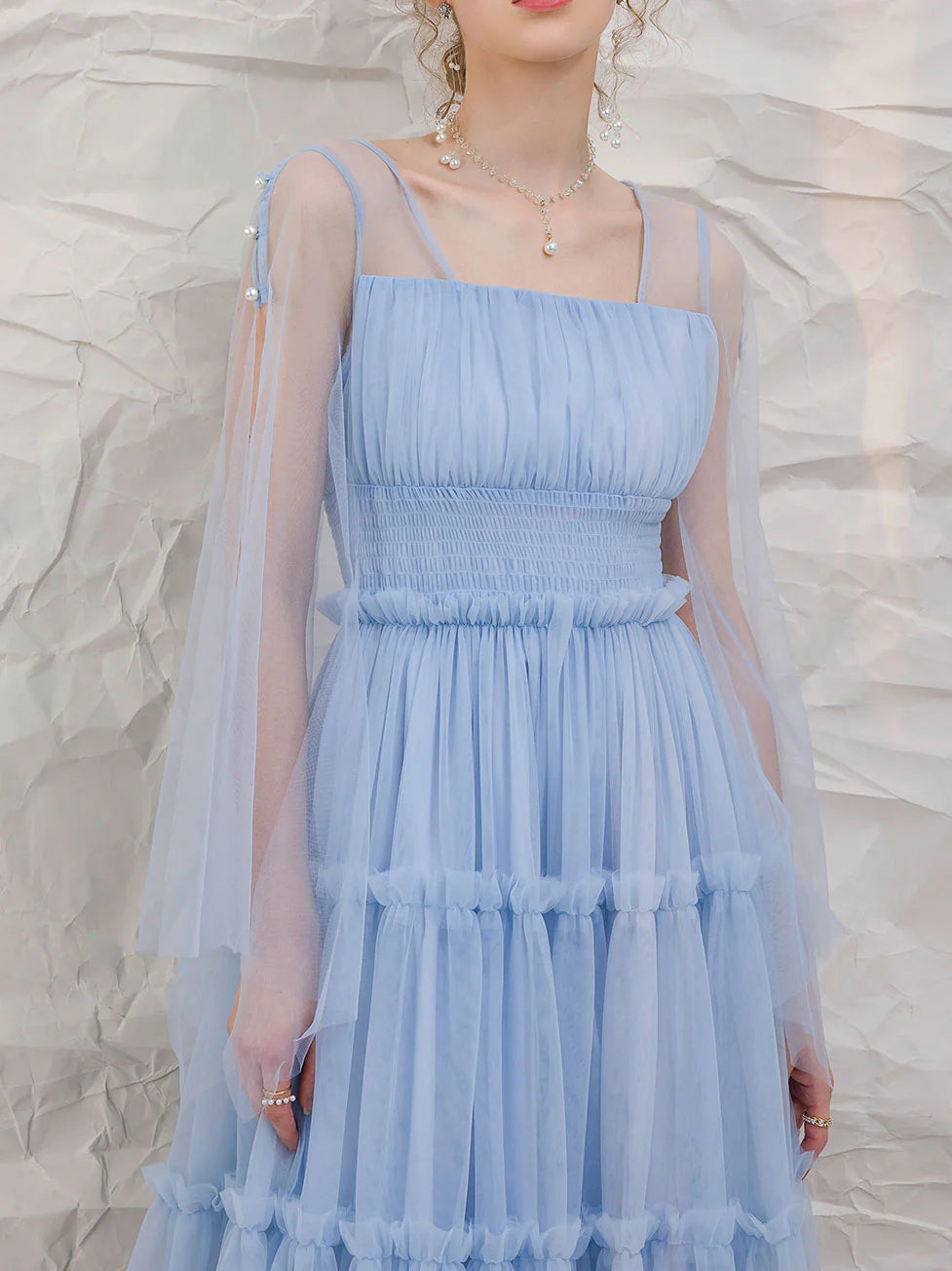 Back view of the blue tulle tea-length prom dress.