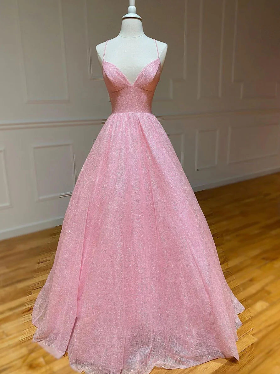 Model wearing a pink A-line V-neck tulle long prom dress with spaghetti straps.
