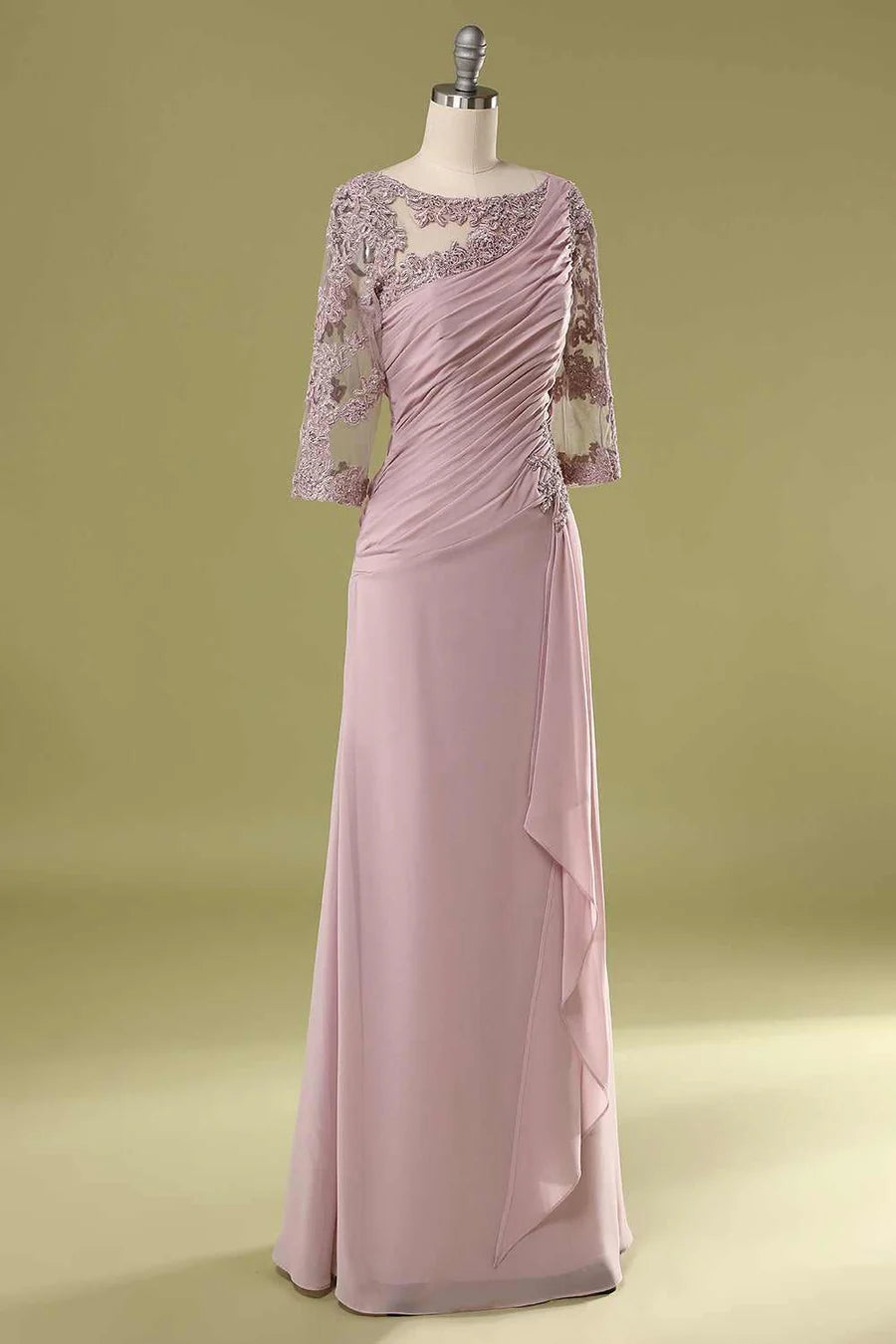 Model wearing a blush pink asymmetrical ruffled half sleeve mother of the bride dress, side view, highlighting ruffle detail.
