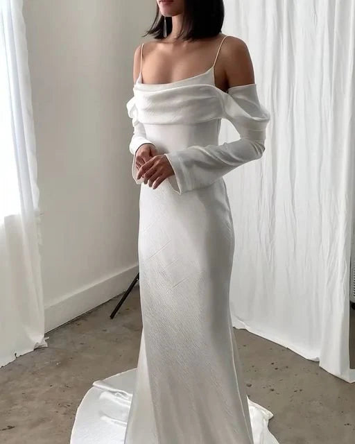 Elegant backless mermaid wedding dress with spaghetti straps and long sleeves.
