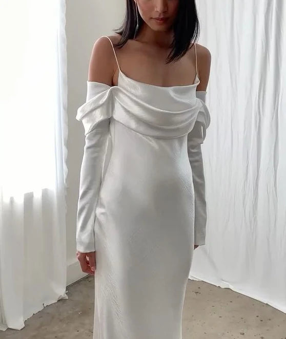 Side view of the backless mermaid wedding dress, highlighting long sleeves and train.