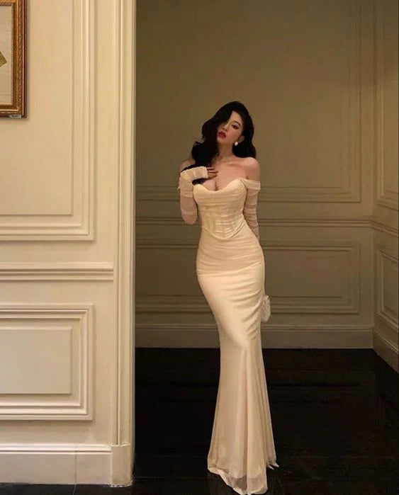 Woman in an elegant black mesh patchwork formal evening gown.