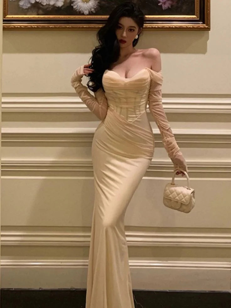 Woman walking gracefully in a black mesh patchwork evening gown.