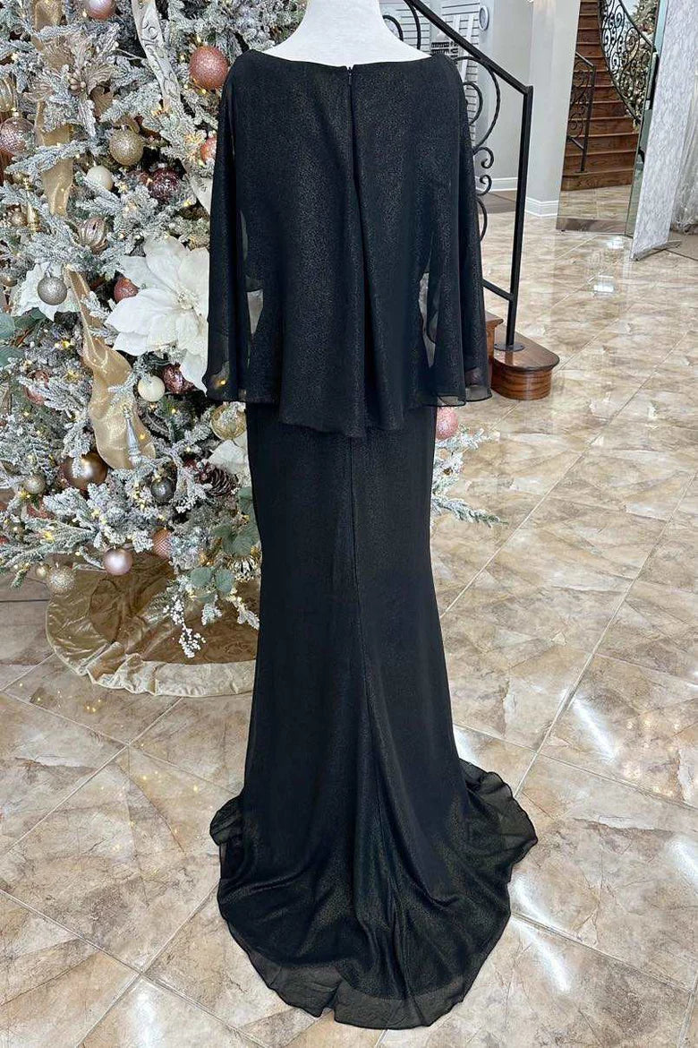 Side view of the black formal gown, showcasing its flowing cape sleeves and long train.