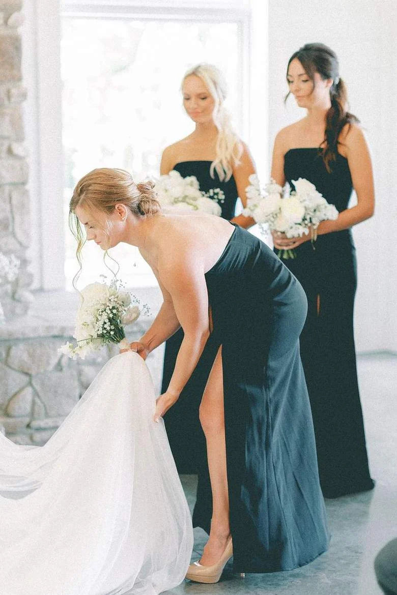 Back view of the long black strapless mermaid satin dress, showcasing its elegant train.
