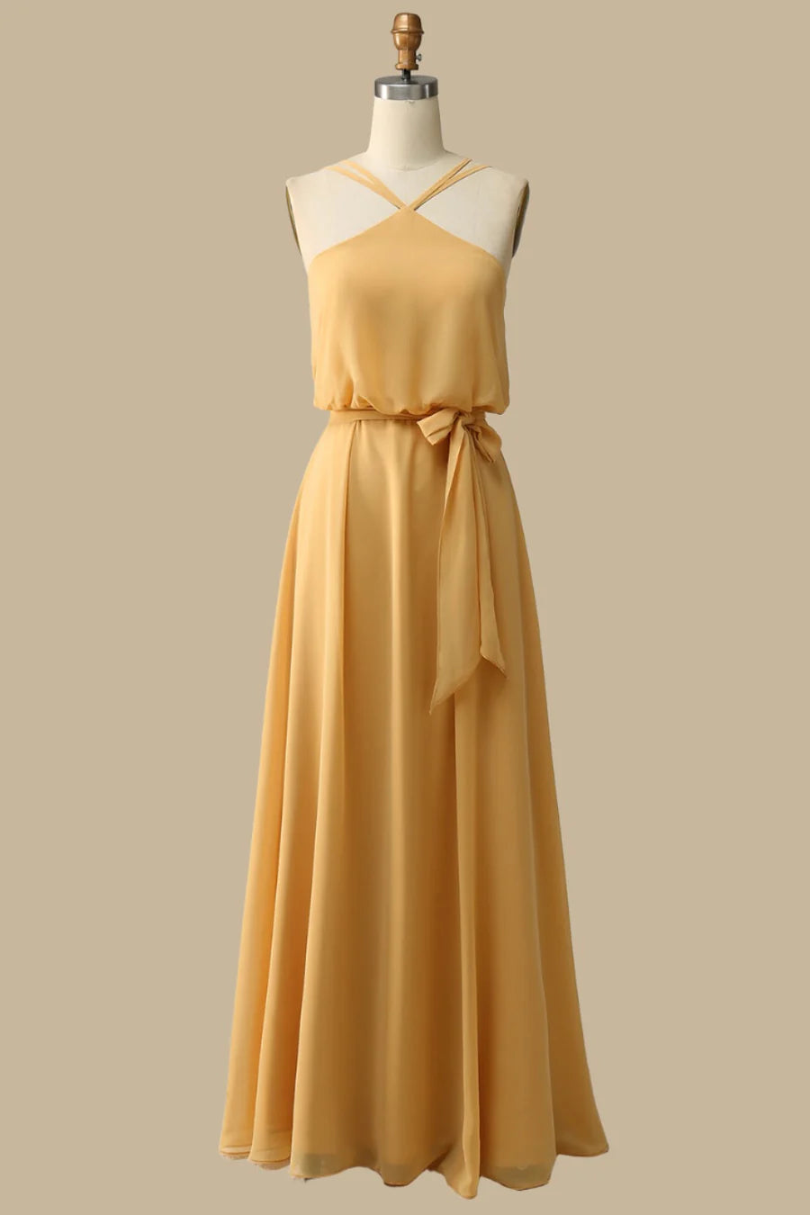 Woman wearing a mustard yellow blouson-style halter maxi dress.