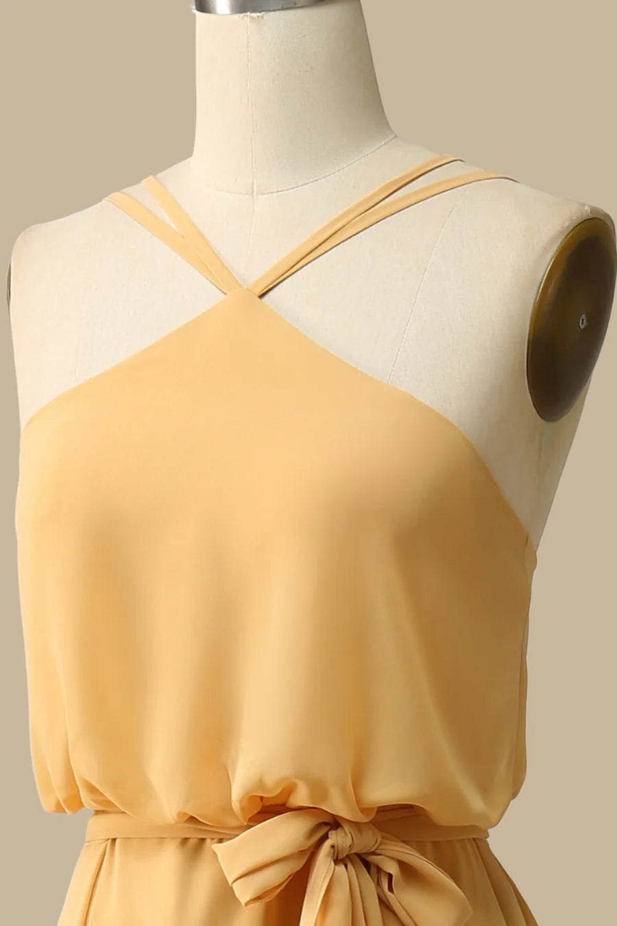 Close-up of the blouson bodice and halter neckline of the mustard yellow dress.