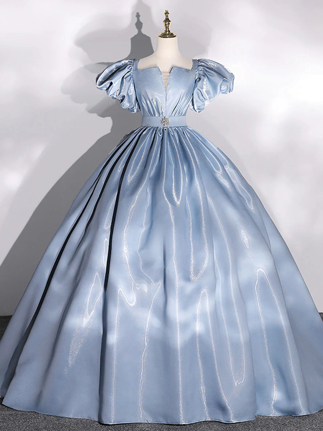 Elegant blue ball gown with puff sleeves, front view.