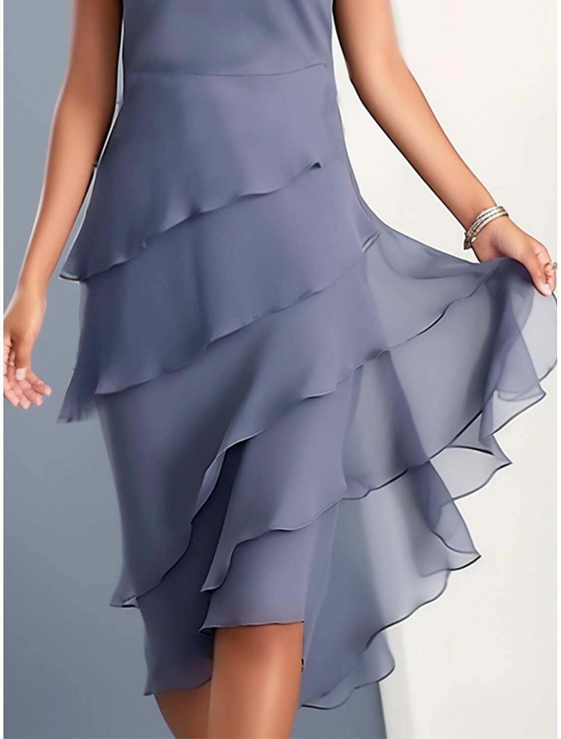 Side view of a woman in the blue fall party dress with ruffle details.