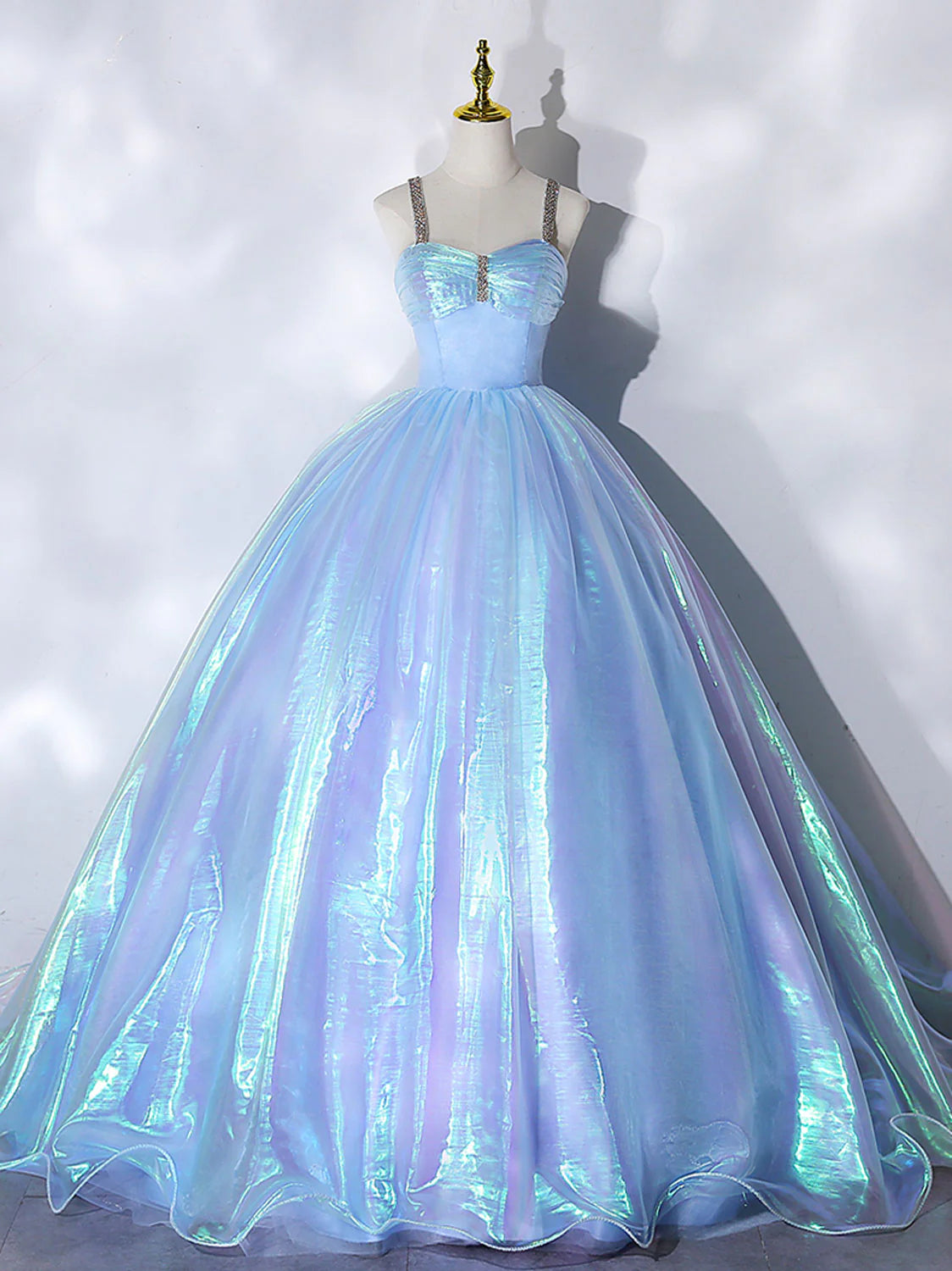 Model wearing an elegant blue tulle ball gown with a sweetheart neckline.