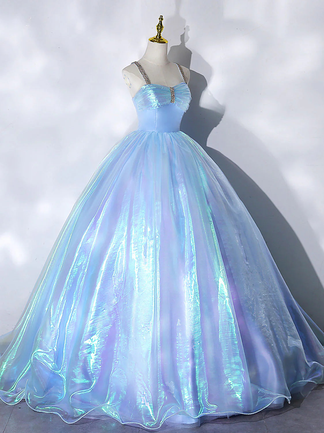 Back view of the long blue formal evening dress with a flowing tulle skirt.