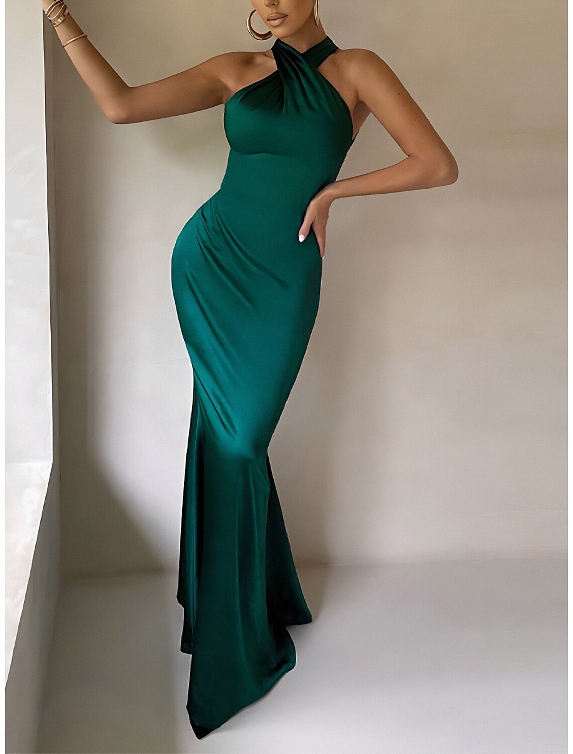 Woman in a stylish black sleeveless bodycon dress, full length.