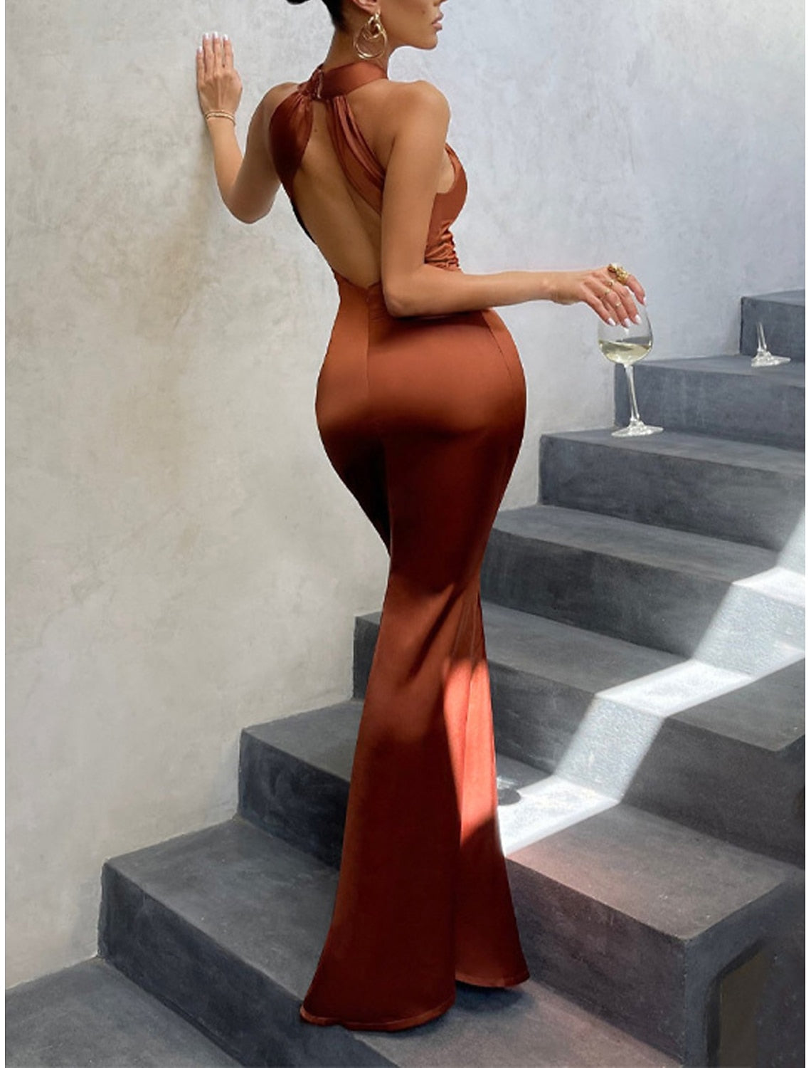 Woman modeling a black bodycon dress, highlighting its elegant fit.