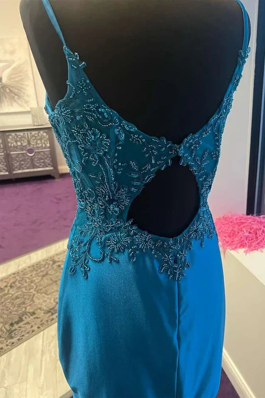 Side view of a woman in a peacock blue bodycon dress featuring appliques.
