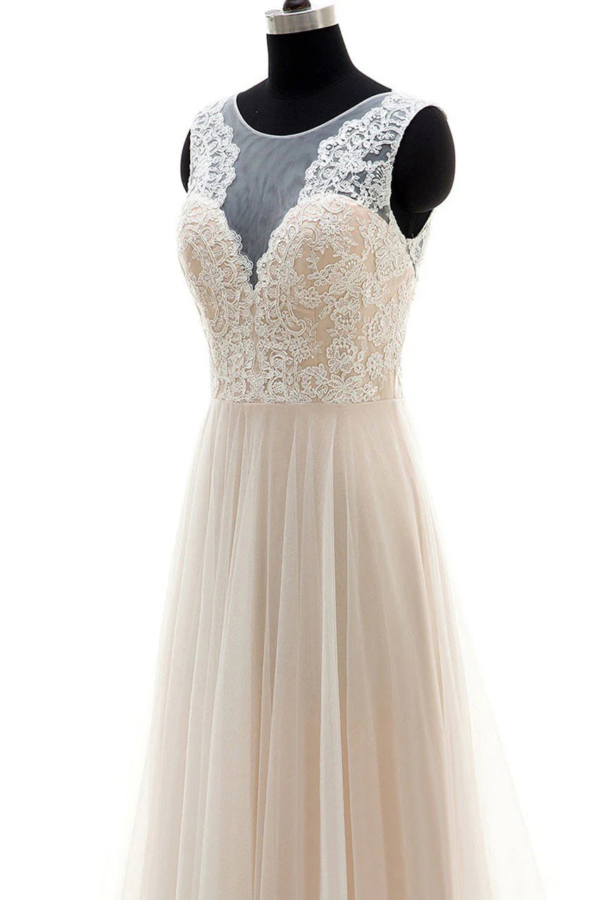Close-up of the delicate champagne tulle and lace fabric with a round neckline.