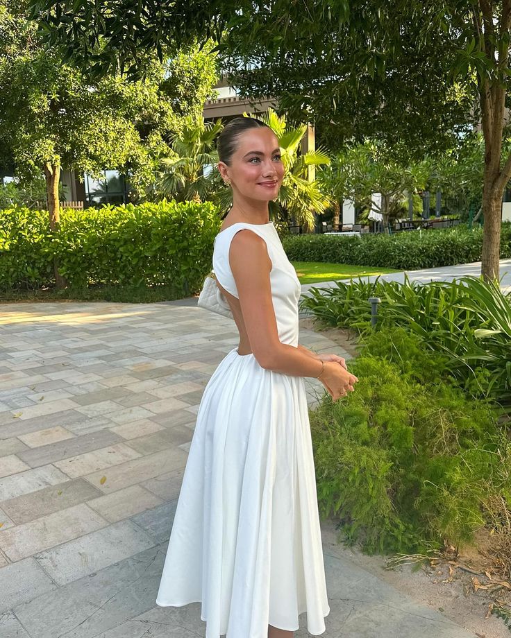 Back view of a white elegant backless prom dress.