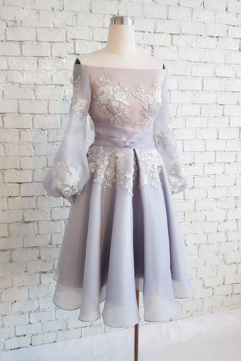 Model wearing a gray chiffon lace short prom dress with delicate applique.